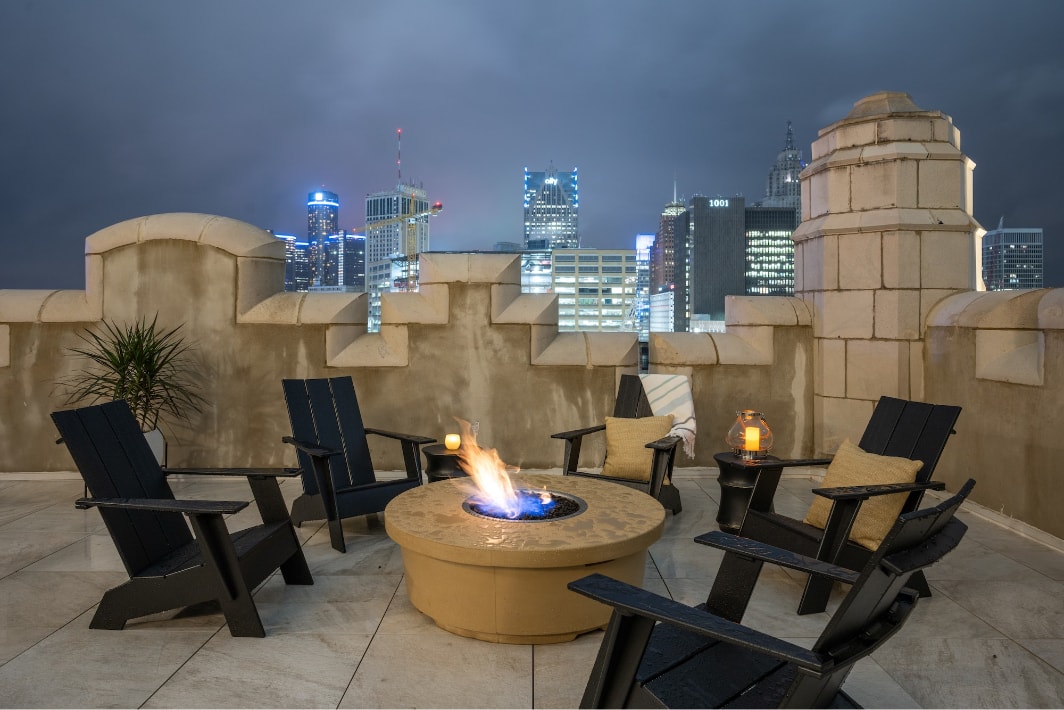 The exterior patio with parapet walls and views of the downtown skyline.